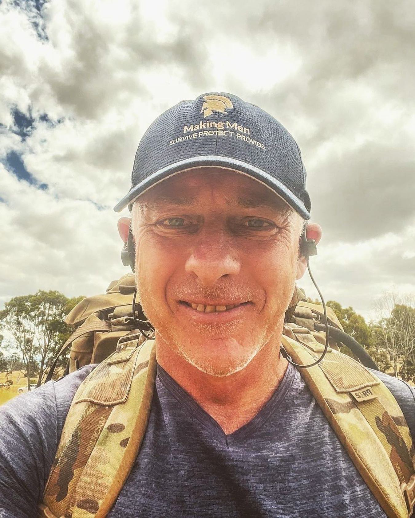 Will Collett on a ruck march wearing a Making Men cap and field pack