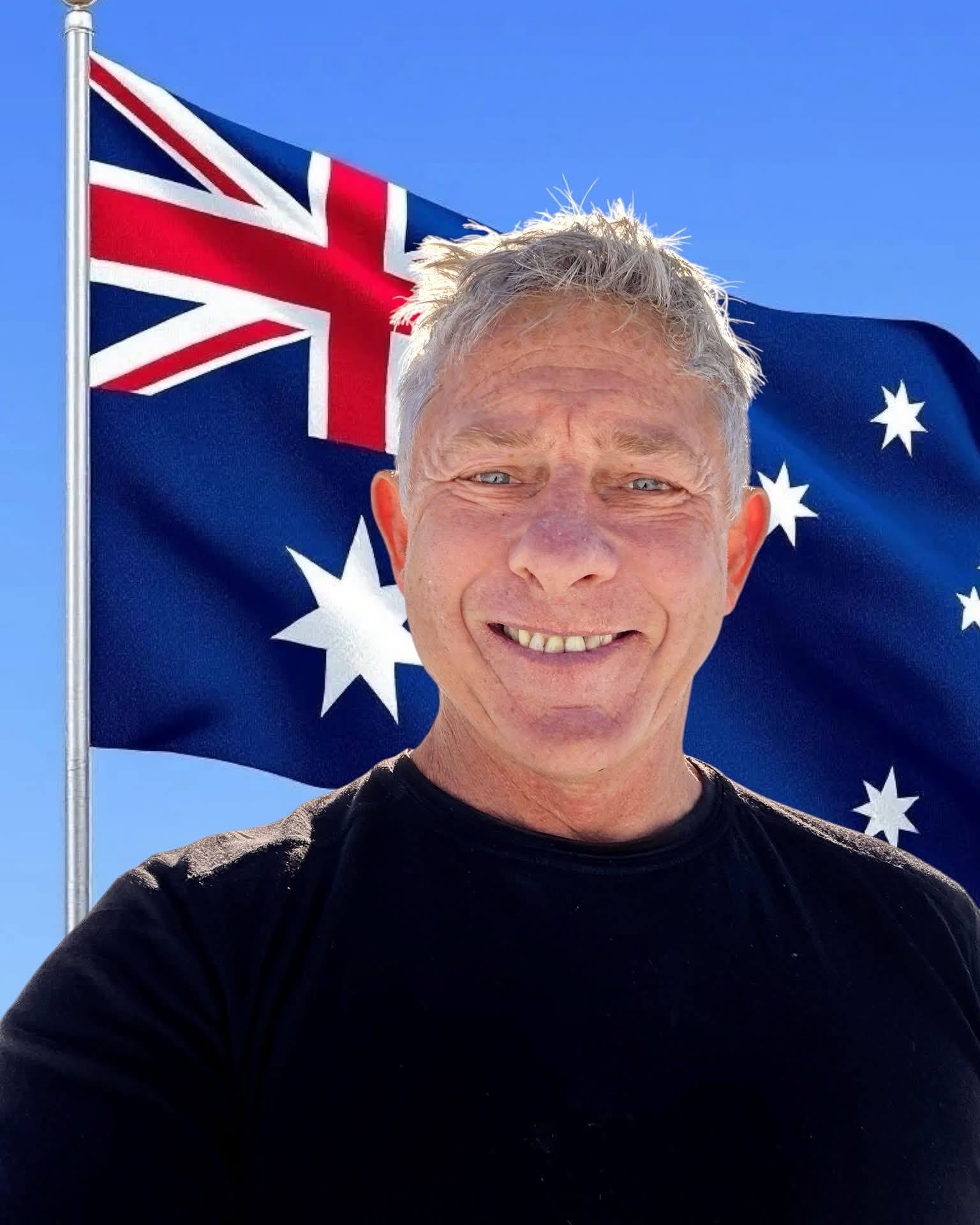 Will Collett in front of an Australian flag