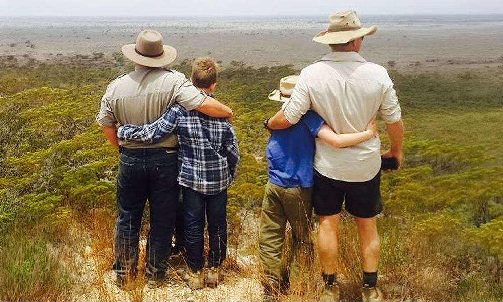 Will Collett mentoring — adults and boys looking out over the land together
